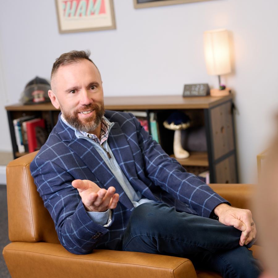 A McKenzie Strategies clinician speaking warmly with a client